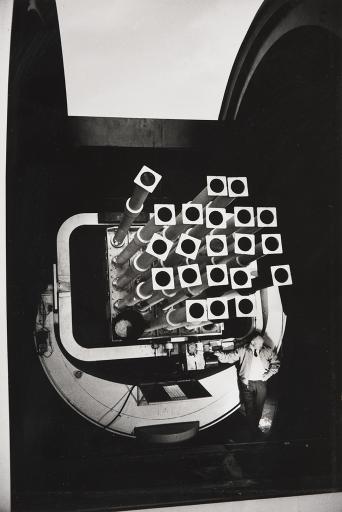 “This huge twenty-five-lensed tracking camera, computer coordinated, finds and follows satellites and other space objects at Holliman Air Force Base. It can see in near darkness.”